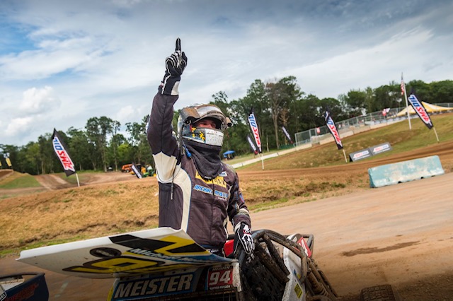 Michael Meister holds up number finger after winning race