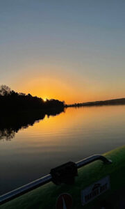 2022_FishingWinner_2_vert A sunset photo taken on the water from the boat