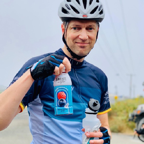 cyclist holding Shine bottle