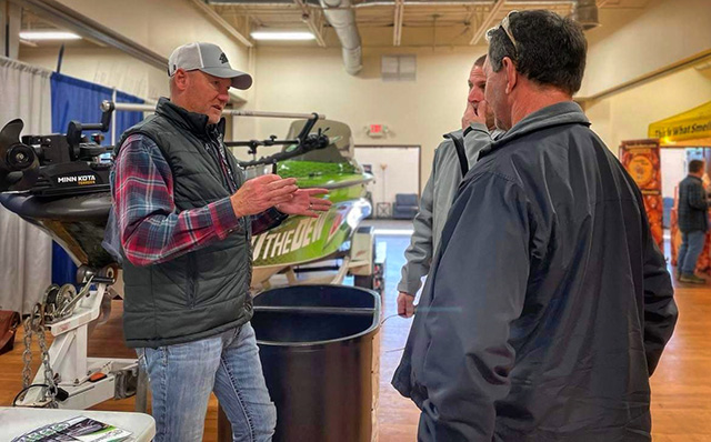 Fishing pro Kurt Walbeck talks with enthusiasts in front of Mountain Dew sponsored fishing boat