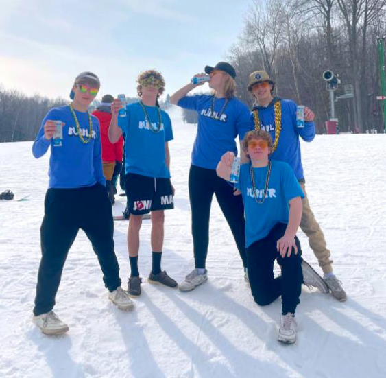 five guys wearing blue Bubbl'r tshirts pose on a snowy ski hill