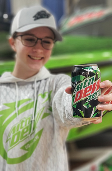 young fan holds up Mountain Dew Zero