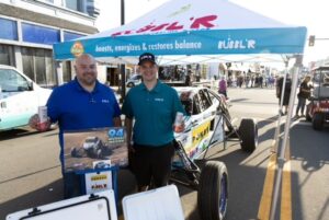 Antigo-Race-Bubblr-IMG_5810 two men holding cans of Bubblr stand in front of the Bubblr off road car