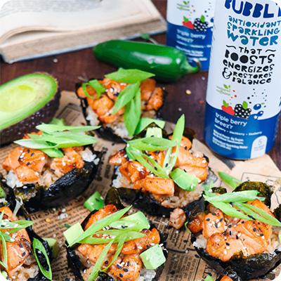 a can of triple berry breez'r Bubbl'r next to several mini salmon sushi nori cups